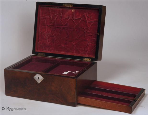 Ref: 640JB:  A richly figured burr walnut  box with mother of pearl escutcheons with lift-out tray and sprung drawer fitted for jewelry. There is a lift-out gold embossed leather framed mirror in the lid with a document wallet behind. The box has a working lock and key  Circa 1850. Enlarge Picture